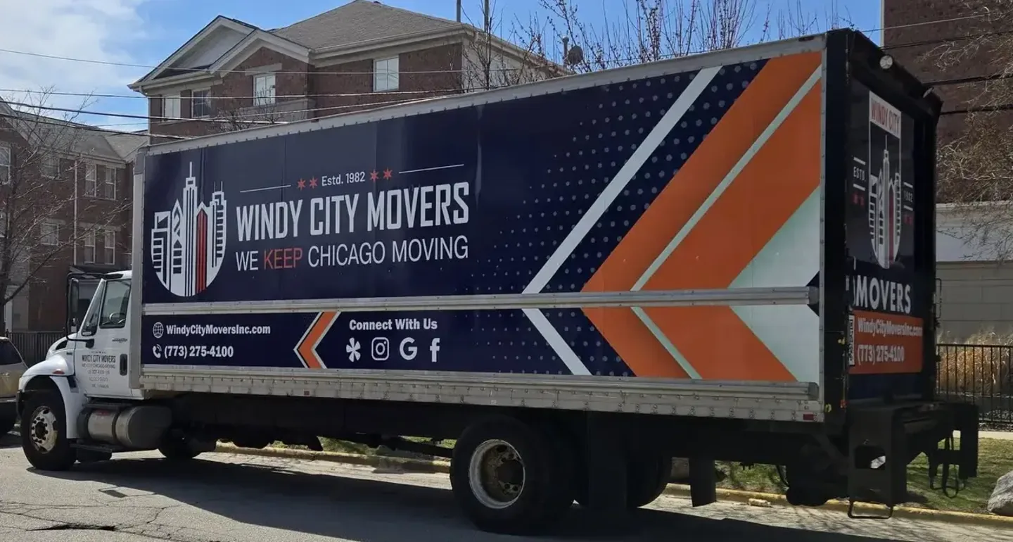 Windy City Movers branded box truck on a Chicago street - one of 19,400 vehicles wrapped by Chicago Fleet Wraps